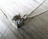 white topaz claw set pendant