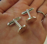 Round cufflinks engraved with initials and date