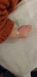 Baby bracelet with cut out initial
